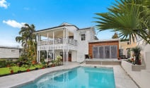 white house with pool and palm trees